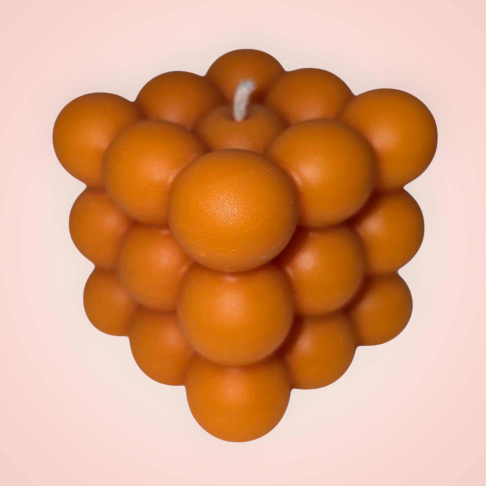 Bright orange bubble cube candle with modern geometric design, hand-poured soy wax, perfect for contemporary home décor and vibrant accents.