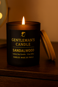 The Gentleman's Sandalwood Candle in a sleek black jar, offering a rich, warm, and sophisticated sandalwood scent for a masculine and calming ambiance.