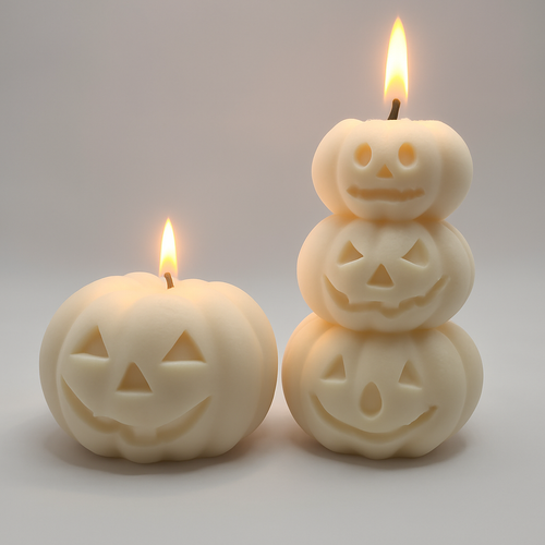 Two Halloween-themed candles with jack-o'-lantern faces on a light gray background